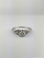 Front view of ring showing central diamond and surrounding accents