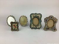 Five miniature flower mosaic picture frames displayed against white background, showing full set with varying floral designs and shapes.