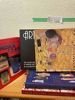 Photo showing five art and collectible reference books including Depression Glass, Art Deco, Art Nouveau, Royal Doulton Figures, and Poole Pottery references.