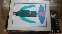 Framed color stencil print 'Ikaluk/Ulu' by Jessie Oonark on flat surface