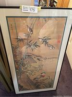 Full view of framed artwork showing bamboo and birds