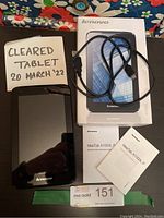 Front view of Lenovo IdeaTab A1000L-F with power cord, box, and instruction manuals included in the lot