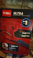 Photo of Toro Ultra electric blower vacuum mulcher box front showing product, branding, and specs