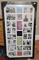 Front view of unopened collage picture frame showing black frame with 28 photo openings arranged in a grid. Included alternate titles and captions visible within the openings.