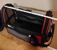 Top view of the Stanley Fat-Max tool bag showing the interior and a measuring tape stretched across the open top, measuring about 12 inches wide.