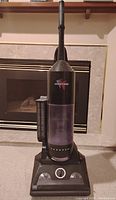 Front view of Fantom Thunder vacuum showing upright design, clear dust chamber, and control dial.