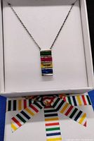 Close-up front view of the 925 sterling silver necklace pendant with five horizontal rectangular stones in green, red, yellow, clear, and blue colors. Pendant displayed on a white background.