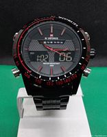 Front view of black NaviForce multifunction quartz wristwatch showing analog and digital displays, day of week, tachymeter bezel and black link bracelet.