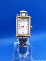 Front view of the rectangular white dial Perry Ellis women's quartz watch showing the time, brand name, and design details on band.