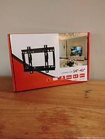 Box of TV wall mount showing front packaging with size indication 14-42 inches.