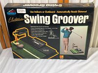 Box of Electronic Swing Groover showing the front panel with usage images and product information.
