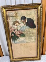 Full view of framed artwork showing man leaning over woman lying in bed, surrounded by flowers, with poem text below.