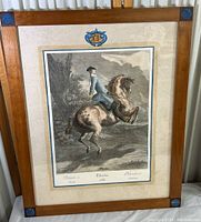 Full view of the framed colored engraving artwork of a rider on a horse, showing the overall condition and framing style.