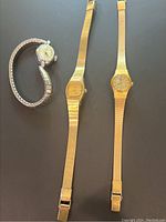 Lot of three ladies vintage gold tone watches showing overall condition and variety in band and face styles.