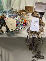 Overview photo showing all assorted vintage costume jewelry spread on a surface, including bracelets, earrings, necklaces and boxed items.