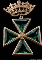 Full brooch showing the Maltese Cross with emerald green glass triangular pieces and attached crown top