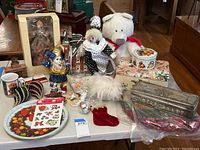 Full lot overview showing figurines, tins, trays, plush bear, and stocking.