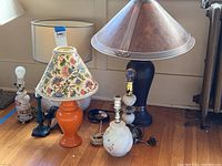 Group photo showing all seven lamps together, highlighting the size differences and styles.
