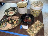 Photo showing all two ice buckets and five decorative trays arranged on a table.