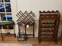 Photo of wooden wine racks, side table, and wire wine rack grouped together, showing size and style contrast