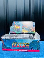 Front view of an open box tray filled with Magic the Gathering cards, showing the Lost Caverns of Ixalan branding.