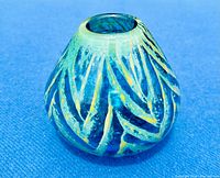 Front view of the Mdina Blue Summer glass vase showing the blue glass body with yellow striped and speckled side pattern on a blue background.