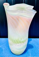 Front view of Shirley Elford signed art glass vase showing pastel swirled colors and ruffled top.