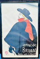 Full view of framed Aristide Bruant dans son Cabaret poster showing the figure in profile with signature red scarf and black cape.