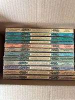 Stack of vintage Dandelion Library children's books showing spines and titles