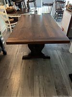 Front view of extended table showing full length and trestle base