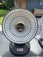 Front view showing the circular front grille and central Presto Heat Dish logo on black base.