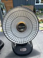 Front view showing the round heating element with black metal grill and Presto HeatDish branding.