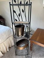 Full view of 5-shelf towel rack with ornamental leaf design, marble soap shelf, waste paper basket, and accessory holder in oil rubbed bronze finish.