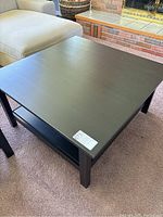 Top view of the square dark wood coffee table showing flat tabletop surface and clean finish.