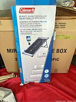 Box showing Coleman branding and product image of crystalline solar panel kit with stand, 40 watts, 12 volts.