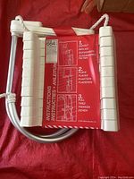Folded fire escape ladder with instructions label attached, showing steps to unfold and place the ladder.