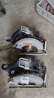 Top view showing two Bosch circular saws, model 691, with visible blades and handles.