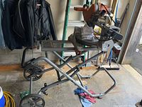 Entire saw and stand assembled in garage, showing overall condition and setup