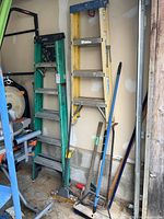 General overview showing two ladders and tools propped against wall