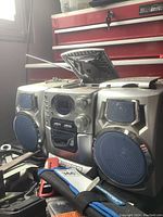 Silver CD player with dual built-in speakers