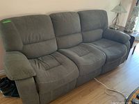 Front view of grey 3-seat reclining sofa