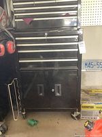 Full view of black two-piece tool chest on caster wheels