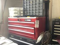 Full view of Mastercraft red tool box with four drawers and key lock, dimensions sticker visible.