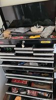 Front view of Stanley tool chest showing multiple drawers with tools and accessories inside.