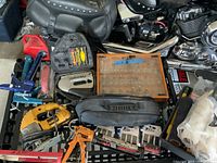 Overview of all tools including Stanley stapler, Dewalt jig saw, paint tray with roller covers, router bits case, orange caulking tool, wire brushes, reciprocating saw in bag.