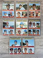 Eight 1969 Topps Baseball Leader cards laid out on a flat surface showcasing various leaders in National League and American League categories such as RBI, Strikeout, ERA, and Pitching.