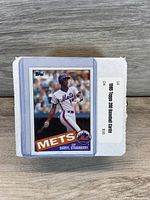 Photo showing the box of 1985 Topps 200 Baseball Cards with Darryl Strawberry card on top in protective sleeve.