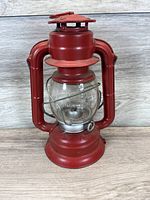 Front view of red Dietz Comet lantern showing overall condition and design details.