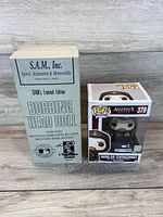Sammy Sosa limited edition bobbing head doll in box alongside Funko Pop Assassin's Creed Aguilar figure in box.