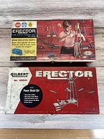 Two Gilbert Erector Set boxes placed one on top of the other showing vintage packaging graphics.